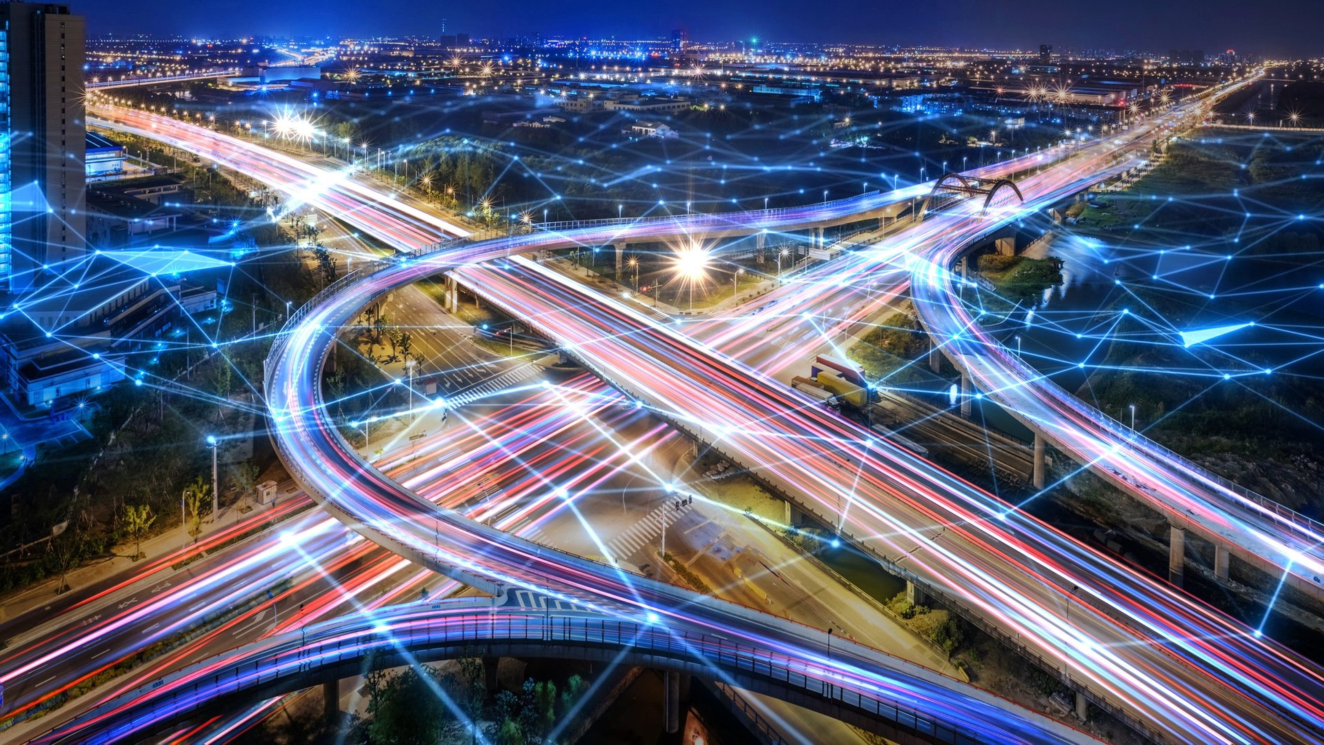 Rush hour traffic fast moving hyper lapse at night overhead of busy intersection.