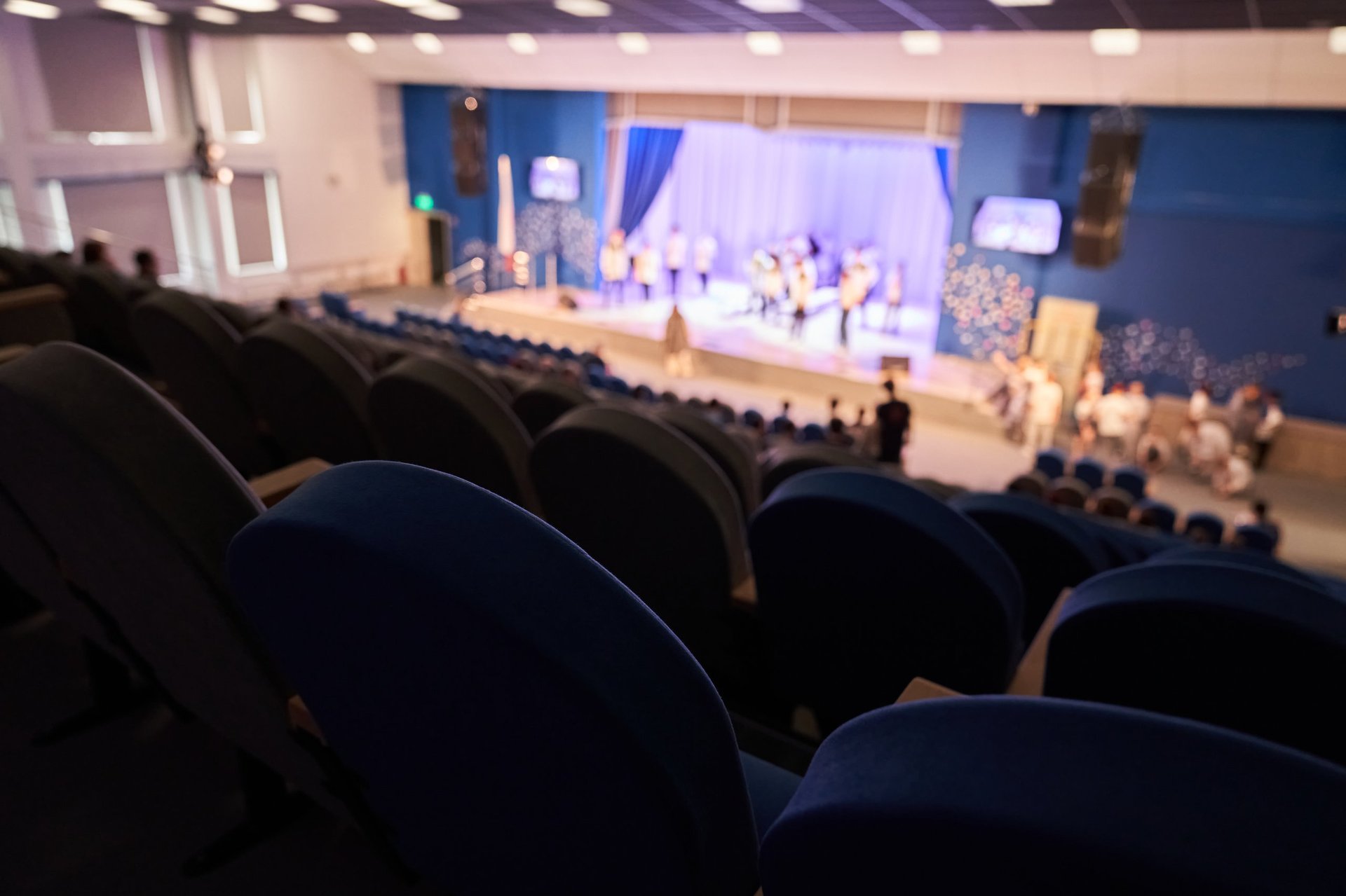 The rehearsal of the play. People in the auditorium are watching the performance.